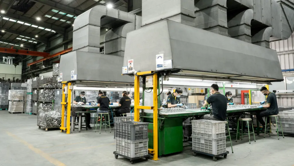 JoinCast's 170-person professional team performing manual quality inspection and assembly within a vertically integrated aluminum die casting facility in Taiwan.