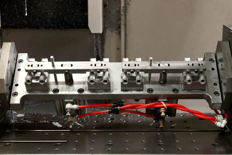 Specialized CNC machining jig securing aluminum die cast enclosures for high-accuracy 4th axis milling operations.