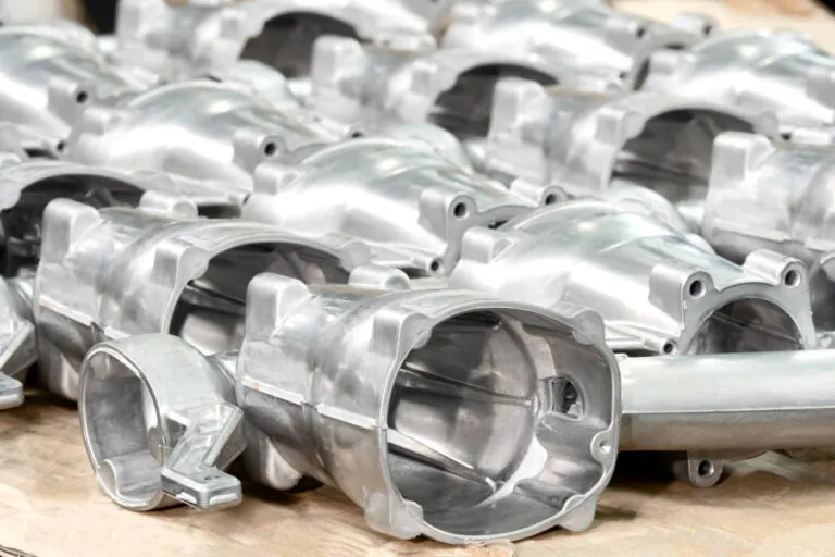 Batch of high-volume aluminum die cast pneumatic tool components ready for vertically integrated surface treatment and finishing.