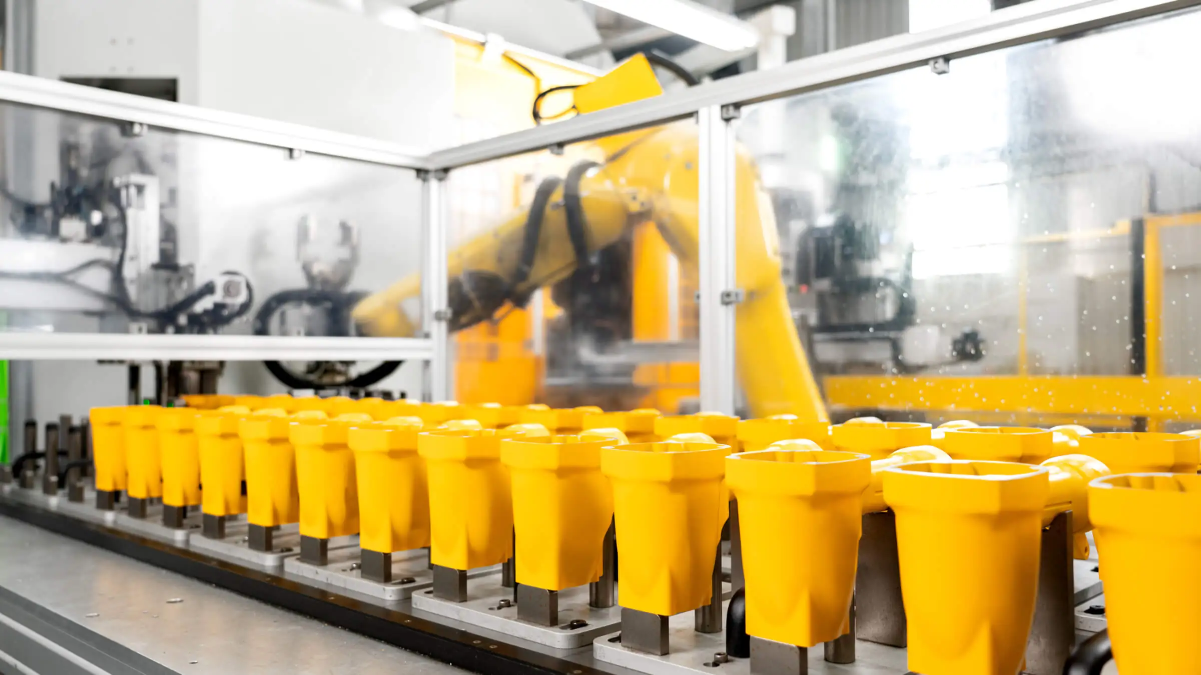 Automated material handling system for aluminum die cast housings undergoing secondary CNC machining processes.