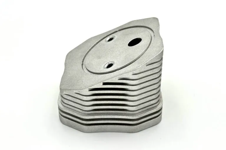 Stacked raw ADC-12 aluminum die castings featuring complex 3D fin geometries to maximize surface area for heat dissipation.
