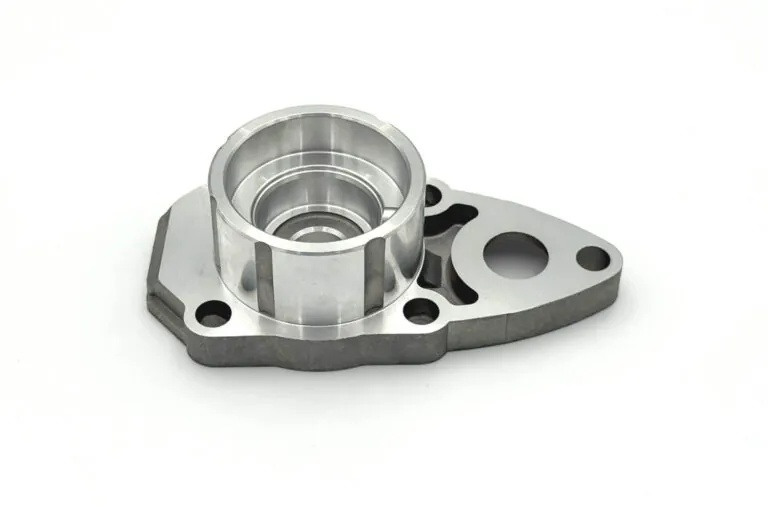 Close-up of a precision CNC machined aluminum component with tight-tolerance bores and a smooth surface finish.