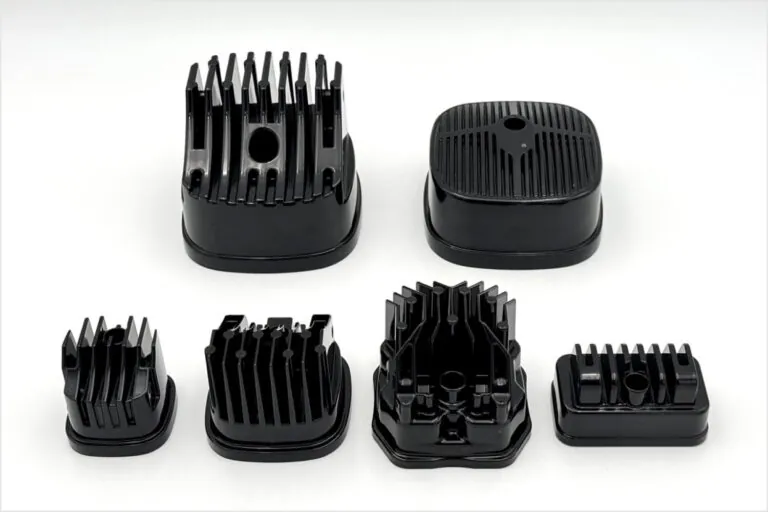 A collection of high-emissivity black liquid-coated and powder-coated aluminum thermal components illustrating diverse surface treatment options.